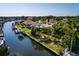 Stunning aerial view of the waterfront property with lush greenery and private boat dock at 9469 Treasure Ne Ln, St Petersburg, FL 33702