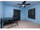 Bedroom with ceiling fan, desk area, dark curtains, and light blue walls at 9469 Treasure Ne Ln, St Petersburg, FL 33702