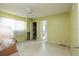 Bright bedroom with a ceiling fan, closet, and doorway leading to another room at 9469 Treasure Ne Ln, St Petersburg, FL 33702