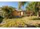 View of the house with well established landscaping at 9469 Treasure Ne Ln, St Petersburg, FL 33702