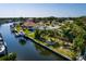 Waterfront home with grassy yard, mature trees, and private boat dock at 9469 Treasure Ne Ln, St Petersburg, FL 33702