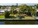 Waterfront home with mature palm trees overlooking the canal on a sunny day at 9469 Treasure Ne Ln, St Petersburg, FL 33702