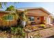 Charming single-story home with an inviting front porch and colorful landscaping at 9469 Treasure Ne Ln, St Petersburg, FL 33702