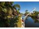 Scenic waterfront view with lush vegetation, boat dock and view of the water at 9469 Treasure Ne Ln, St Petersburg, FL 33702