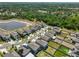 An aerial view of the community highlighting the pond, trees, and neighborhood streets at 9914 Calypso Orchid Ct, Riverview, FL 33578