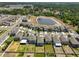 Bird's-eye view of the community displaying backyard privacy fences and a tranquil pond at 9914 Calypso Orchid Ct, Riverview, FL 33578
