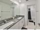 Bathroom featuring double sinks with granite counters, tile floor, and shower at 9914 Calypso Orchid Ct, Riverview, FL 33578
