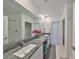 Bathroom showcasing dual sinks with granite countertop, a large mirror, and a shower/tub combination at 9914 Calypso Orchid Ct, Riverview, FL 33578