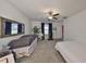 Bright bedroom showcasing a ceiling fan, ample space, and natural light, offering a serene and relaxing ambiance at 9914 Calypso Orchid Ct, Riverview, FL 33578