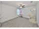 Bright and airy bedroom features a ceiling fan, neutral decor, and a vanity station, creating a relaxing atmosphere at 9914 Calypso Orchid Ct, Riverview, FL 33578