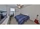 Bedroom with work space featuring ceiling fan, window, and a comfortable bed at 9914 Calypso Orchid Ct, Riverview, FL 33578