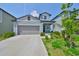 Charming light blue two-story home with a two-car garage and well-maintained landscaping at 9914 Calypso Orchid Ct, Riverview, FL 33578
