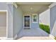 Inviting front porch with a black front door, neutral mat, and manicured landscaping at 9914 Calypso Orchid Ct, Riverview, FL 33578