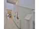 Bright hallway featuring tile floors, a modern storage unit, and staircase to the second floor at 9914 Calypso Orchid Ct, Riverview, FL 33578