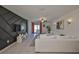 Bright living room with white sofa, unique accent wall, modern decor, and sliding door access to the backyard at 9914 Calypso Orchid Ct, Riverview, FL 33578