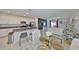 Open-concept living space with a kitchen island and tile flooring that connects the living room and dining area at 9914 Calypso Orchid Ct, Riverview, FL 33578