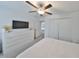 Main bedroom features plush carpet, closet doors, neutral decor and TV for relaxation at 9914 Calypso Orchid Ct, Riverview, FL 33578