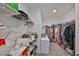Well-organized walk-in closet with ample shelving and hanging space for optimal storage and convenience at 9914 Calypso Orchid Ct, Riverview, FL 33578