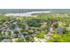 An aerial perspective exhibits the home within a lake-bordered community, immersed in greenery at 2207 Climbing Ivy Dr, Tampa, FL 33618