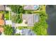 An aerial view of a home with a pool, lush landscaping, and a charming brick driveway at 2207 Climbing Ivy Dr, Tampa, FL 33618