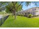 The screened-in lanai and manicured lawn overlook a tranquil pond, creating a perfect outdoor retreat at 2207 Climbing Ivy Dr, Tampa, FL 33618