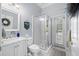Modern bathroom with glass-enclosed shower, marbled vanity, tile floor, and a door to the outside pool area at 2207 Climbing Ivy Dr, Tampa, FL 33618