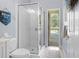 Bathroom with glass shower, white tile and view to lanai at 2207 Climbing Ivy Dr, Tampa, FL 33618