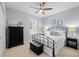 Comfortable bedroom with a ceiling fan, shutters and black furniture at 2207 Climbing Ivy Dr, Tampa, FL 33618