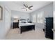 Well lit bedroom with ceiling fan, shutters, and black furniture at 2207 Climbing Ivy Dr, Tampa, FL 33618