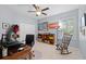 Comfortable bedroom with ceiling fan, rocking chair, and natural light at 2207 Climbing Ivy Dr, Tampa, FL 33618