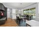 Open dining area with sliding glass doors to the lanai, dark wood table, and bright breakfast bar with modern fixtures at 2207 Climbing Ivy Dr, Tampa, FL 33618