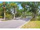 Gated entrance with stone pillars, framed by trees and landscaping, creates an inviting community at 2207 Climbing Ivy Dr, Tampa, FL 33618