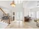 Bright foyer with high ceilings, travertine floors, and an ornate chandelier creating a welcoming ambiance at 2207 Climbing Ivy Dr, Tampa, FL 33618