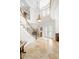 Grand foyer with a winding staircase, stone floors, and high ceilings offering a luxurious and spacious entrance at 2207 Climbing Ivy Dr, Tampa, FL 33618