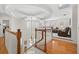 Bright foyer with hardwood floors, a staircase with white railings, and a view into the spacious living area at 2207 Climbing Ivy Dr, Tampa, FL 33618