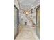 Grand foyer with curved staircase, mosaic tile, and soaring ceilings create an impressive entrance at 2207 Climbing Ivy Dr, Tampa, FL 33618