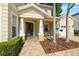 Inviting front porch with stylish columns, a charming seating area, and a view of the manicured landscaping at 2207 Climbing Ivy Dr, Tampa, FL 33618