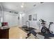 Spacious home gym with exercise equipment, tiled floors, and ample storage space, perfect for fitness enthusiasts at 2207 Climbing Ivy Dr, Tampa, FL 33618