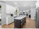 Open kitchen concept connecting the living room, featuring an island with hardwood floors and modern appliances at 2207 Climbing Ivy Dr, Tampa, FL 33618