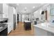 Bright kitchen with white cabinetry, stainless steel appliances, central island, and modern design at 2207 Climbing Ivy Dr, Tampa, FL 33618