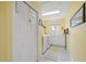 Well-lit laundry room with white cabinetry, folding counter, and washer/dryer units at 2207 Climbing Ivy Dr, Tampa, FL 33618
