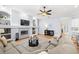 Open-concept living area featuring a fireplace, TV, hardwood floors, and seamless flow to the kitchen at 2207 Climbing Ivy Dr, Tampa, FL 33618