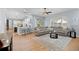Inviting living room featuring a sectional sofa, arched window, open to kitchen, and stylish decor at 2207 Climbing Ivy Dr, Tampa, FL 33618