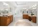 Spacious primary bathroom featuring double vanities, a soaking tub, and ample natural light from plantation shutters at 2207 Climbing Ivy Dr, Tampa, FL 33618