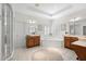 Bright primary bathroom with double vanities, a soaking tub, a walk-in shower, and plantation shutters at 2207 Climbing Ivy Dr, Tampa, FL 33618