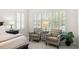 Bedroom featuring seating area by plantation-shuttered windows, offering a cozy and well-lit relaxation space at 2207 Climbing Ivy Dr, Tampa, FL 33618