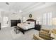Serene main bedroom featuring a tray ceiling, plantation shutters, and elegant furnishings for a relaxing retreat at 2207 Climbing Ivy Dr, Tampa, FL 33618