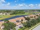 Scenic aerial view showcases a well-maintained community beside a serene lake and golf course at 1003 Fairwaycove Ln # 103, Bradenton, FL 34212
