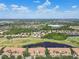 Wide aerial view of townhome community with mature trees, golf course, and lakes at 1003 Fairwaycove Ln # 103, Bradenton, FL 34212