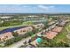 A scenic aerial view features beautiful lake, golf course and community pool at 1003 Fairwaycove Ln # 103, Bradenton, FL 34212